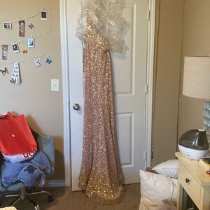 Evening Gown Brand light gold sequence.One shoulder/slip on the right hand leg.